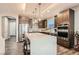 Well-equipped kitchen with a spacious island, stainless steel appliances, and stylish cabinetry at 10936 White Alder Pl, Las Vegas, NV 89138