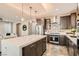 Modern kitchen featuring stainless steel appliances, large island, pendant lighting, and stylish backsplash at 10936 White Alder Pl, Las Vegas, NV 89138