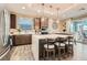 Modern kitchen featuring a large center island, stainless steel appliances, and a view of the dining area at 10936 White Alder Pl, Las Vegas, NV 89138