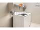 Functional laundry room with side-by-side Samsung washer and dryer for efficient cleaning at 10936 White Alder Pl, Las Vegas, NV 89138