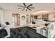 Spacious living room with plush seating, sleek hardwood floors, and an open layout to the kitchen at 10936 White Alder Pl, Las Vegas, NV 89138