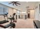 Spacious upstairs loft with an exercise area, featuring a treadmill, bike, and weight bench at 10936 White Alder Pl, Las Vegas, NV 89138