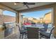 Covered outdoor kitchen with a built-in grill, a fire pit table, and comfortable seating at 10936 White Alder Pl, Las Vegas, NV 89138