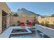 Relaxing pool and spa with a built-in water feature, framed by lush landscaping and lounge chairs at 10936 White Alder Pl, Las Vegas, NV 89138