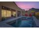 Inviting pool and spa area with an integrated waterfall feature and mountain views at 10936 White Alder Pl, Las Vegas, NV 89138