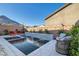 Backyard pool and spa area with an integrated water feature, surrounded by lounge seating at 10936 White Alder Pl, Las Vegas, NV 89138