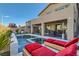 Backyard pool and spa area, complemented by lounge chairs and an outdoor dining area at 10936 White Alder Pl, Las Vegas, NV 89138