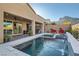 Backyard pool and spa area with mountain views, an integrated water feature, and lounge seating at 10936 White Alder Pl, Las Vegas, NV 89138