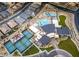 Aerial view of the community clubhouse, multiple pools, tennis courts, and neighborhood homes at 11161 Black Fire Opal Dr, Las Vegas, NV 89138