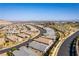 Expansive aerial view showcasing a vibrant community near desert mountains and city skyline at 11161 Black Fire Opal Dr, Las Vegas, NV 89138