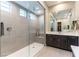 Modern bathroom featuring a large glass shower, tile walls, and a double sink vanity with ample counter space at 11161 Black Fire Opal Dr, Las Vegas, NV 89138
