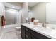 Bathroom with double sink vanity, tiled floors, and a shower-tub combo for added convenience at 11161 Black Fire Opal Dr, Las Vegas, NV 89138
