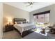Cozy bedroom features a large window, soft carpet, and comfortable seating for relaxation at 11161 Black Fire Opal Dr, Las Vegas, NV 89138