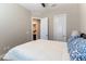 Comfortable bedroom with a queen bed and ensuite bath, featuring neutral walls and a ceiling fan at 11161 Black Fire Opal Dr, Las Vegas, NV 89138