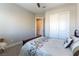 Cozy bedroom featuring plush carpet, a ceiling fan, and a large closet with bi-fold doors at 11161 Black Fire Opal Dr, Las Vegas, NV 89138