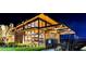 Stunning architectural design with floor to ceiling glass, showcasing a cozy and well-lit community clubhouse at night at 11161 Black Fire Opal Dr, Las Vegas, NV 89138