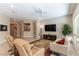 Inviting living room featuring tile floors, neutral walls, and ample natural light through a large picture window at 11161 Black Fire Opal Dr, Las Vegas, NV 89138