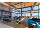 Modern lounge area with comfortable seating, fireplace, and large windows with picturesque views at 11161 Black Fire Opal Dr, Las Vegas, NV 89138
