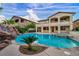 An exquisite backyard offers a custom rock slide, pool, and spa at 12283 Lost Treasure Ave, Las Vegas, NV 89138
