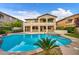 Expansive backyard with a refreshing pool, spa, lush landscaping, outdoor kitchen, and a large patio for entertaining guests at 12283 Lost Treasure Ave, Las Vegas, NV 89138