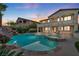 Resort-style backyard featuring a pool, spa, and covered patio, perfect for outdoor entertaining at 12283 Lost Treasure Ave, Las Vegas, NV 89138