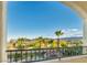 Balcony with views of palm trees, landscaping, and mountain backdrop. Wrought iron railing and arched openings at 12283 Lost Treasure Ave, Las Vegas, NV 89138