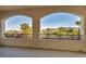 Inviting covered balcony showcasing scenic neighborhood views of palm trees and distant mountains at 12283 Lost Treasure Ave, Las Vegas, NV 89138