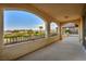 Wide covered balcony with arched openings offering expansive views of palm trees and hills at 12283 Lost Treasure Ave, Las Vegas, NV 89138