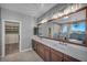 Spacious bathroom with double sinks, wood cabinets, a large mirror, and a walk-in closet for ample storage at 12283 Lost Treasure Ave, Las Vegas, NV 89138