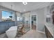 A modern bathroom features a standalone tub, glass shower, tile accent wall, and mountain views at 12283 Lost Treasure Ave, Las Vegas, NV 89138