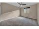 Neutral bedroom with a ceiling fan, carpeted floors, and a window allowing natural light at 12283 Lost Treasure Ave, Las Vegas, NV 89138