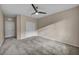 Spacious bedroom with neutral walls, gray carpet, ceiling fan, and closet with sliding doors at 12283 Lost Treasure Ave, Las Vegas, NV 89138