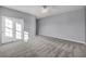 Spacious bedroom with gray walls, plush carpet, a ceiling fan, and a closet with white sliding doors at 12283 Lost Treasure Ave, Las Vegas, NV 89138