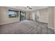 Expansive bedroom with sliding glass doors to balcony and large window with neighborhood views at 12283 Lost Treasure Ave, Las Vegas, NV 89138