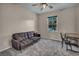 Cozy bedroom with a comfortable couch, desk area and a well lit window at 12283 Lost Treasure Ave, Las Vegas, NV 89138