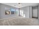 Bright bedroom with gray walls, gray carpet, three windows offering neighborhood views, and a closet at 12283 Lost Treasure Ave, Las Vegas, NV 89138