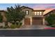 Charming two-story home featuring a three-car garage and well-manicured landscaping at 12283 Lost Treasure Ave, Las Vegas, NV 89138