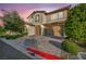 Charming two-story home with a three-car garage, landscaped yard, and brick-paved driveway at 12283 Lost Treasure Ave, Las Vegas, NV 89138