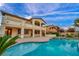 Stunning home exterior showcasing the pristine pool, large patio, and covered second story balconies at 12283 Lost Treasure Ave, Las Vegas, NV 89138