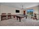 Game room with a ping pong table, pool table, and mounted TV at 12283 Lost Treasure Ave, Las Vegas, NV 89138