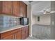 Hallway featuring built-in wood cabinets with marble countertop, tiled backsplash, and minibar at 12283 Lost Treasure Ave, Las Vegas, NV 89138