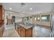 Open kitchen with granite counters, stainless appliances and views to the living area with fireplace at 12283 Lost Treasure Ave, Las Vegas, NV 89138
