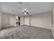 Spacious main bedroom with neutral carpet, ceiling fan, and ensuite bathroom access for modern comfort at 12283 Lost Treasure Ave, Las Vegas, NV 89138