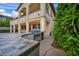Covered patio with custom outdoor kitchen with stainless steel BBQ grill and sink at 12283 Lost Treasure Ave, Las Vegas, NV 89138