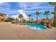 Backyard swimming pool and hot tub, featuring custom rock waterfall and lush landscaping at 12283 Lost Treasure Ave, Las Vegas, NV 89138