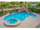 Backyard oasis with a sparkling pool and stone water slide at 12283 Lost Treasure Ave, Las Vegas, NV 89138