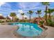 Gorgeous backyard pool with stone waterfall and lush landscaping at 12283 Lost Treasure Ave, Las Vegas, NV 89138