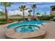 Stunning backyard featuring a refreshing pool, spa, rock waterfall, mature palm trees, and lush landscaping creating a private oasis at 12283 Lost Treasure Ave, Las Vegas, NV 89138