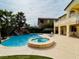 Exterior view of the backyard featuring a private pool, spa, and waterfall, perfect for relaxation and entertaining at 12283 Lost Treasure Ave, Las Vegas, NV 89138