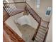 Elegant staircase with wood banister leading to upper level, enhanced by unique chandelier at 12283 Lost Treasure Ave, Las Vegas, NV 89138